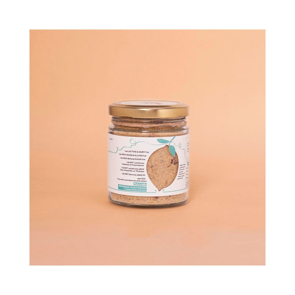 Jar of chai masala with benefits label on a peach-colored background
