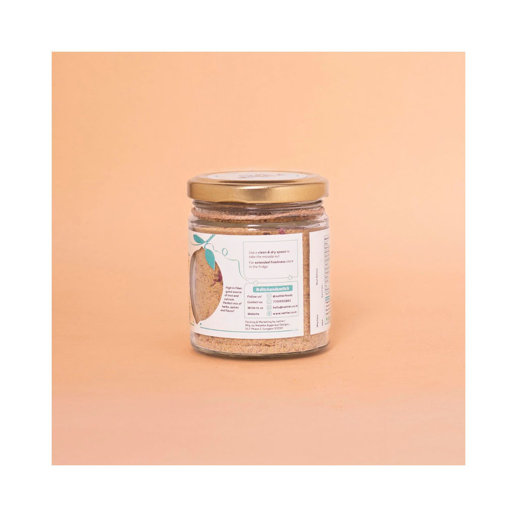 Jar of chai masala with usage label on a peach-colored background