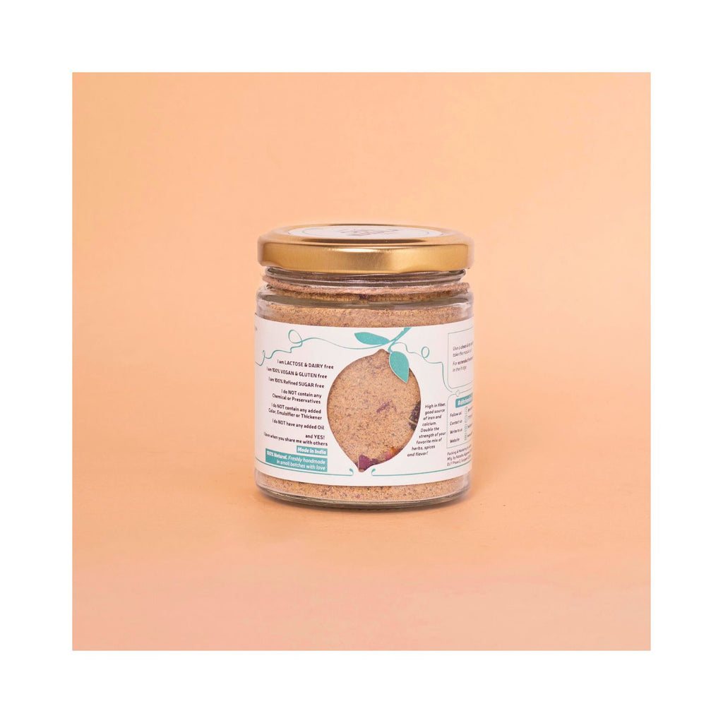 Jar of Nattier Chai Masala with benefits label on a peach background