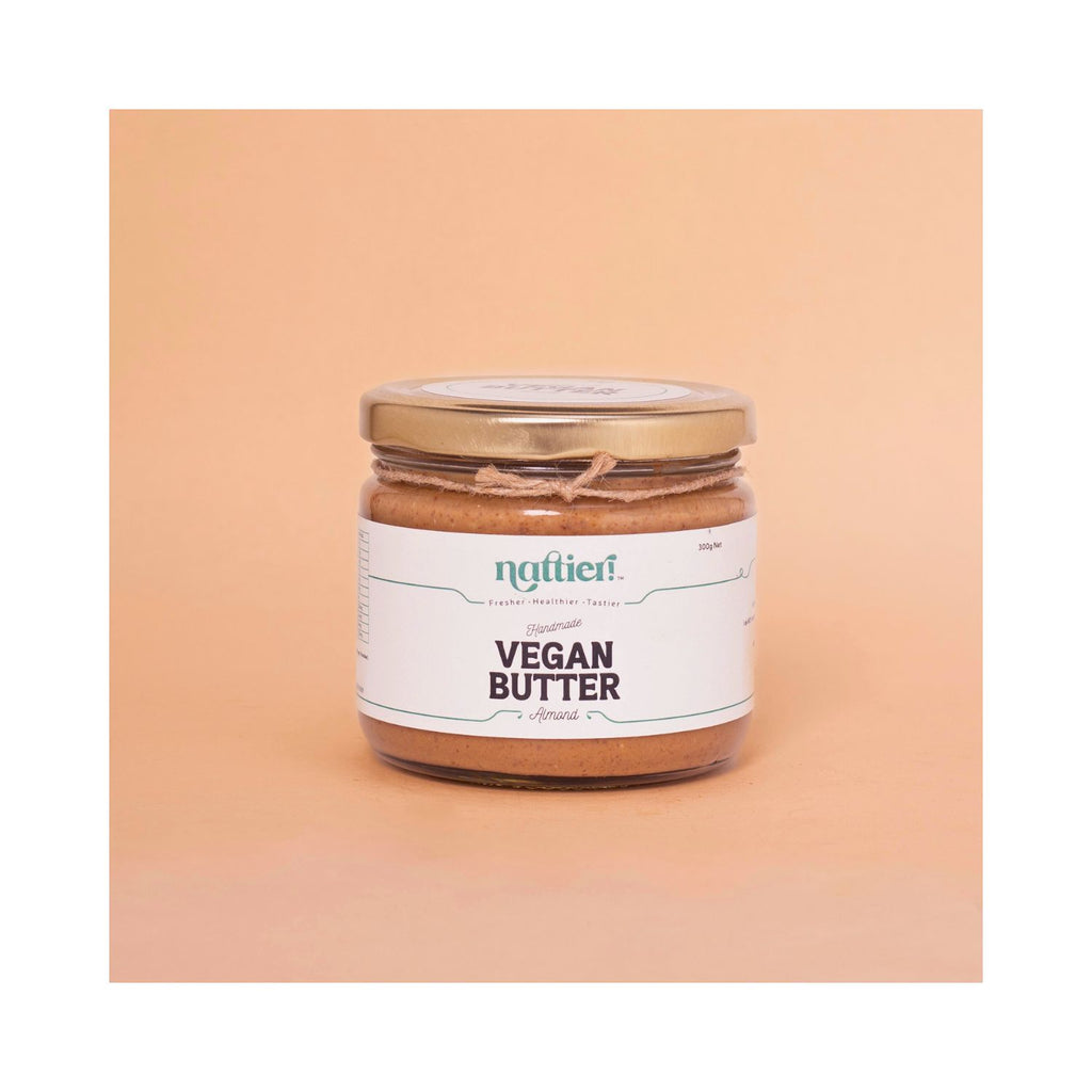 Jar of vegan butter with a label on a peach background