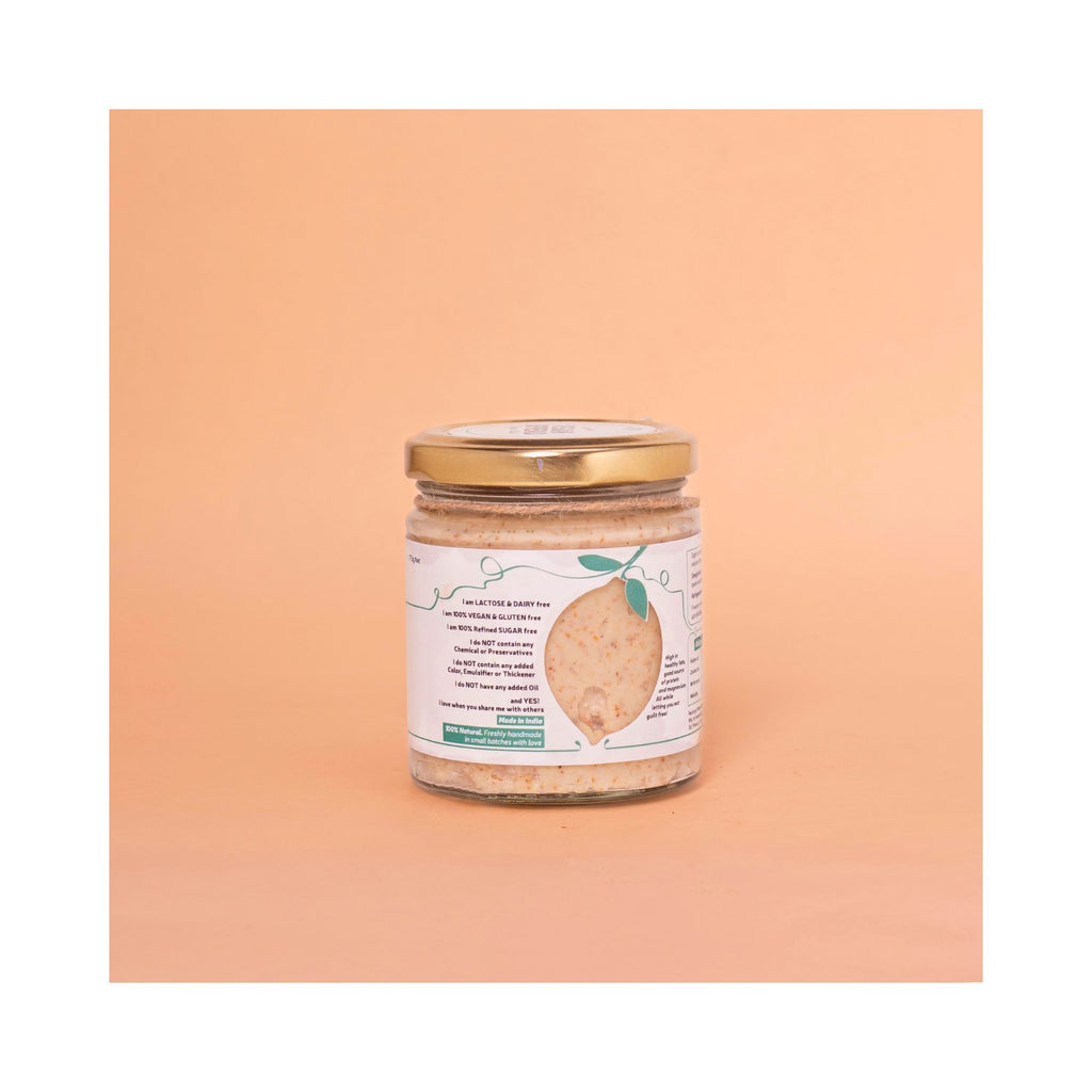 Jar of vegan spread with a gold lid and a white benefits label on a peach background