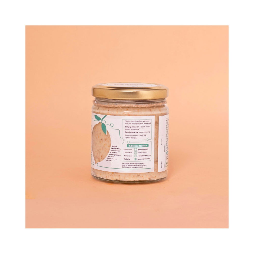 Jar of vegan spread with a gold lid and a white usage label on a peach background