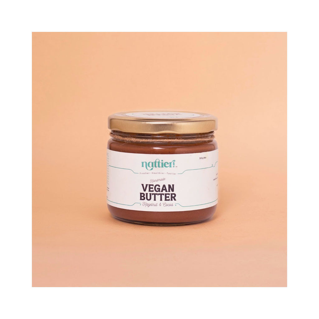 Jar of vegan butter with a white label on a peach background