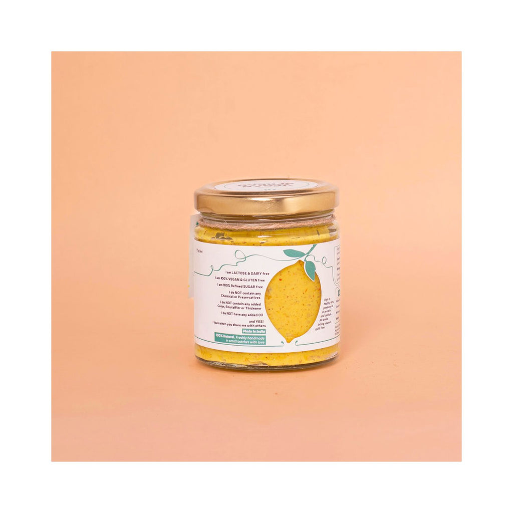 Jar of mustard spread with a benefits label on a peach-colored background