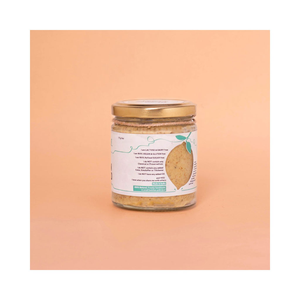 Jar of oregano basil spread with white benefits label on peach background