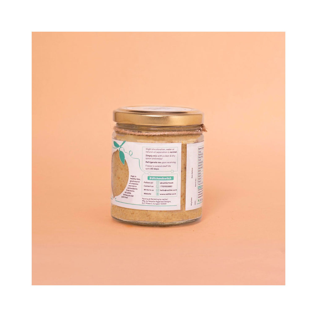 Jar of oregano basil spread with white usage label on peach background