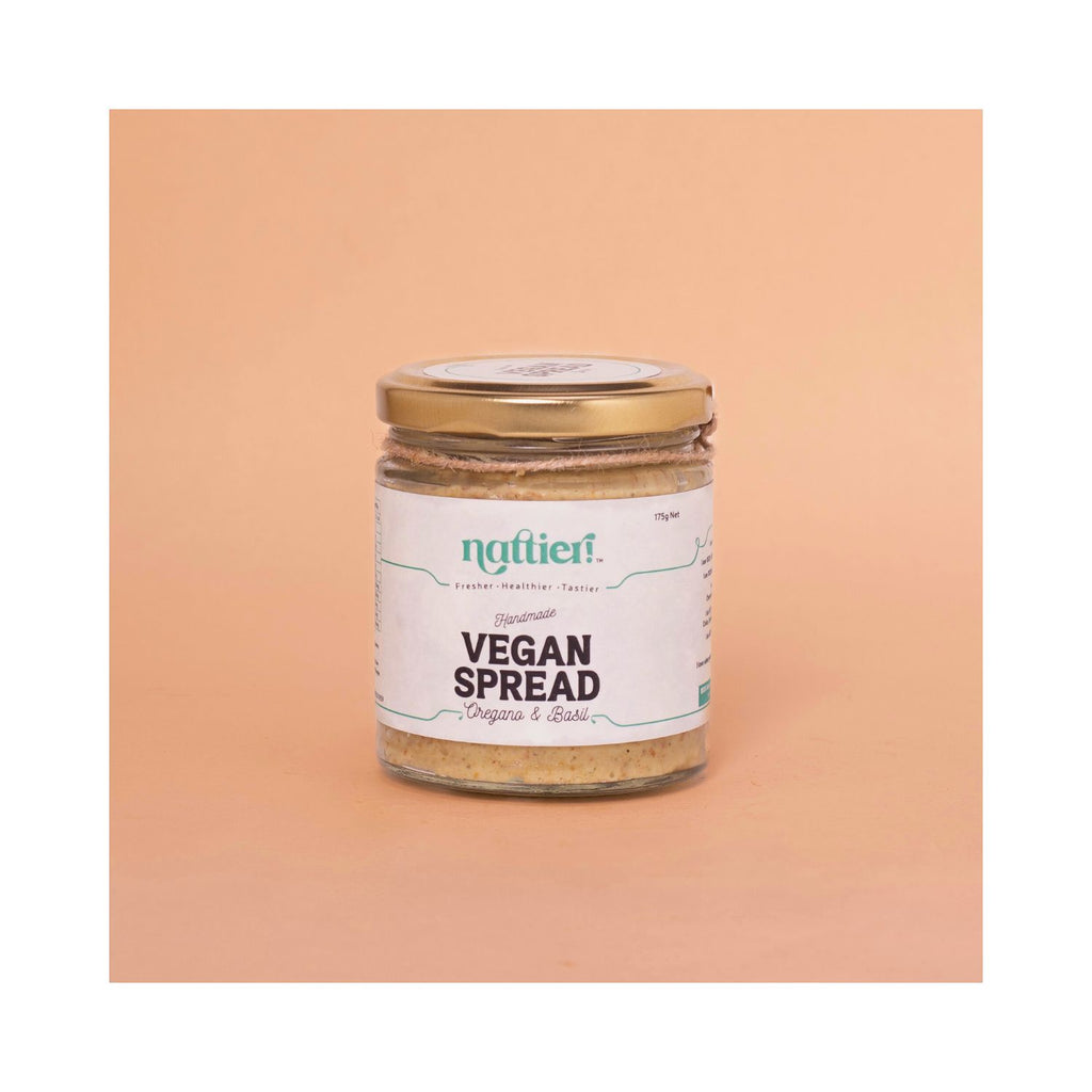 Jar of oregano basil spread with white label on peach background
