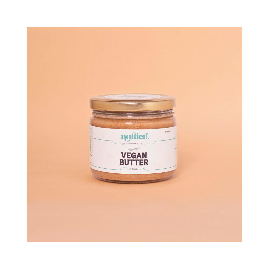 Jar of vegan butter with a label on a peach background