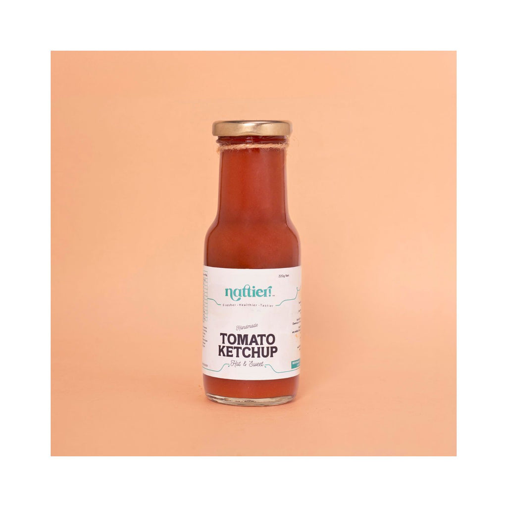 Bottle of hot & sweet ketchup with white label on a peach background