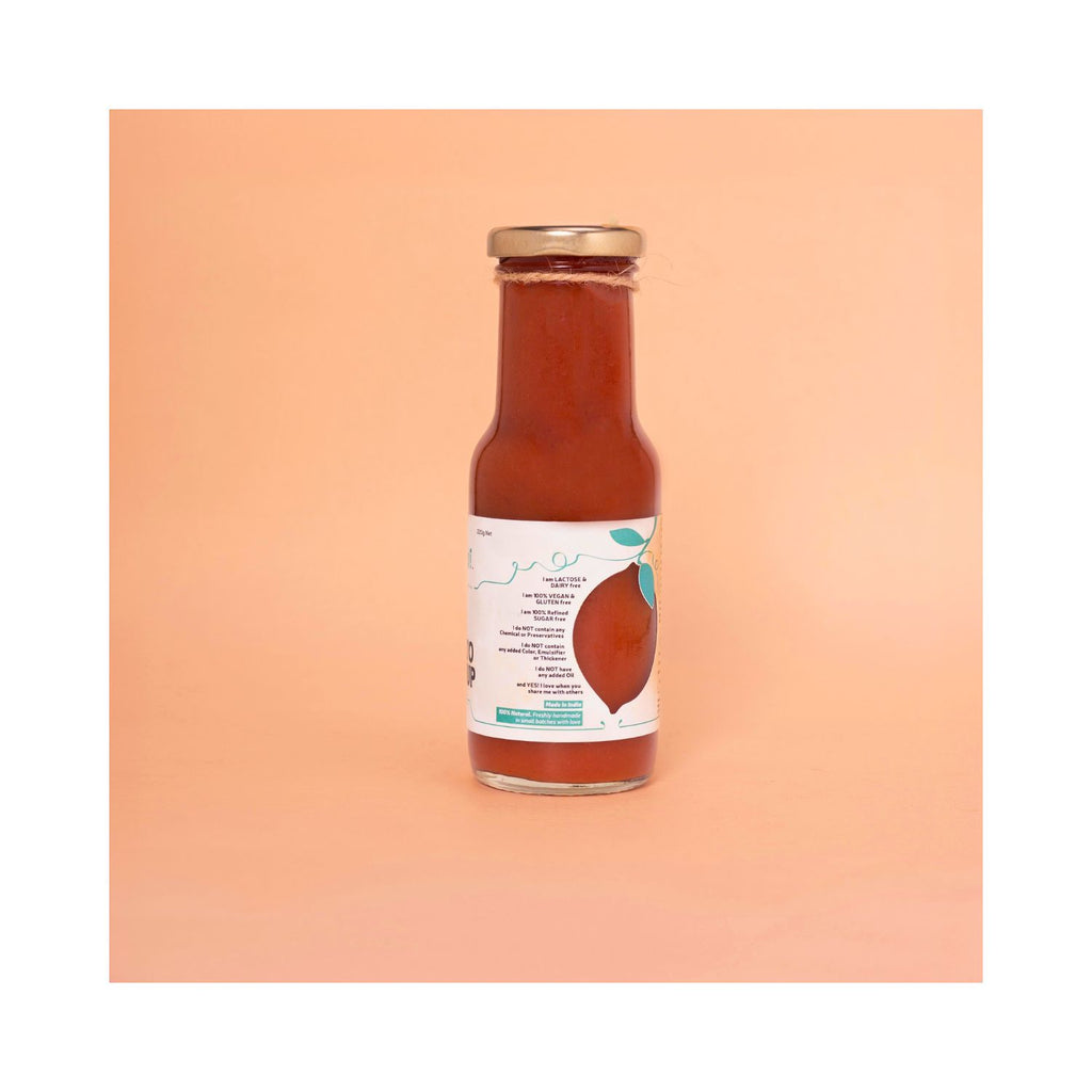 Bottle of hot & sweet ketchup with white benefits label on a peach background