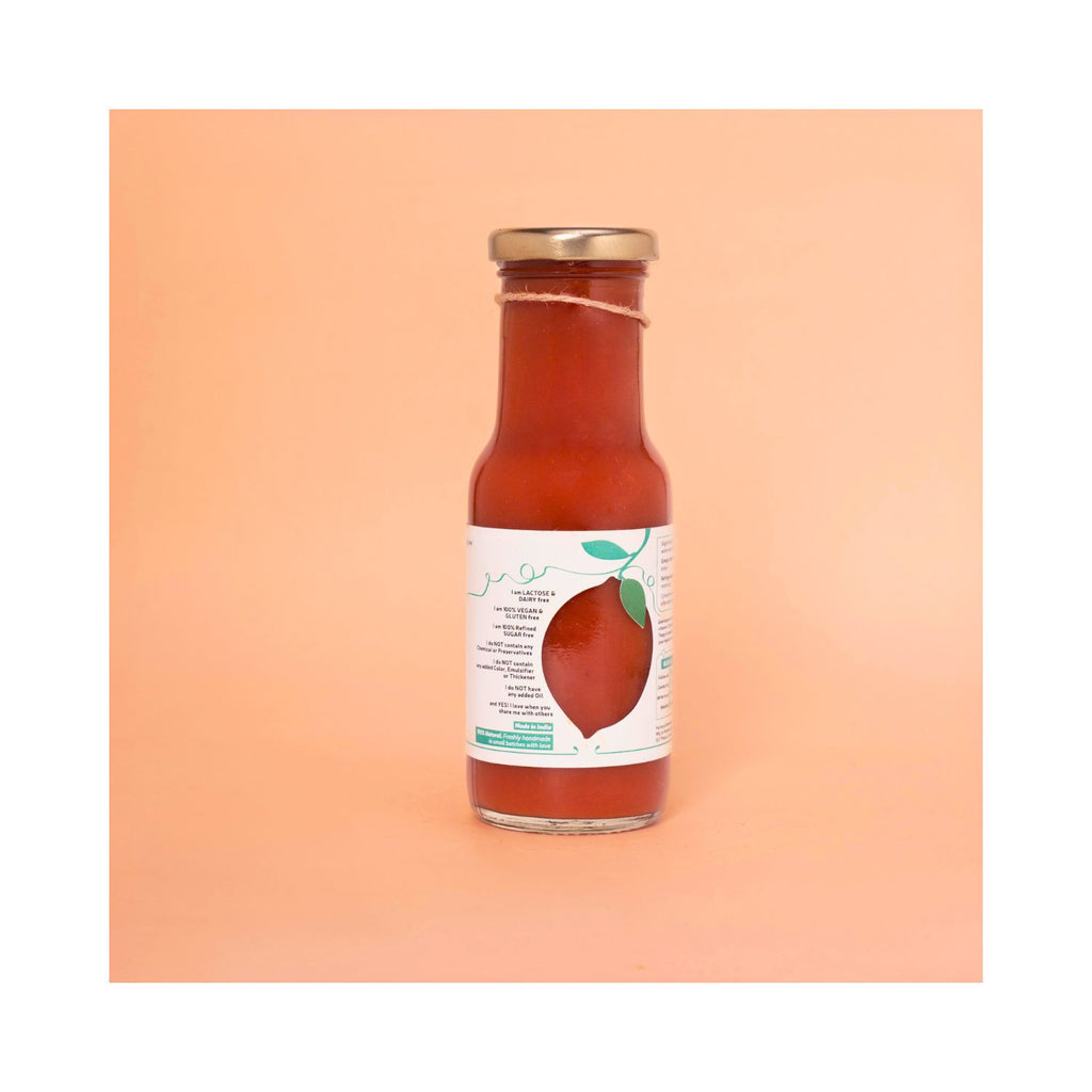 Bottle of ketchup with white benefits label on peach background
