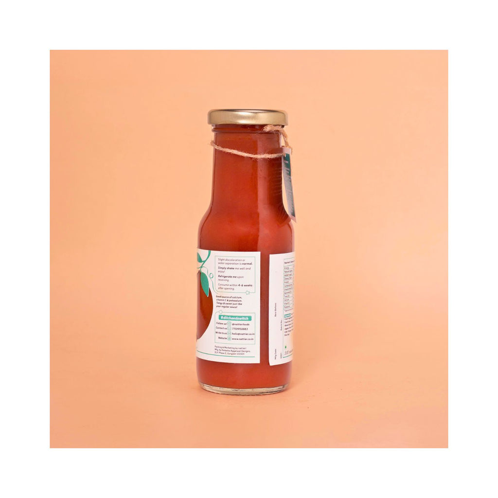 Bottle of ketchup with white usage label on peach background
