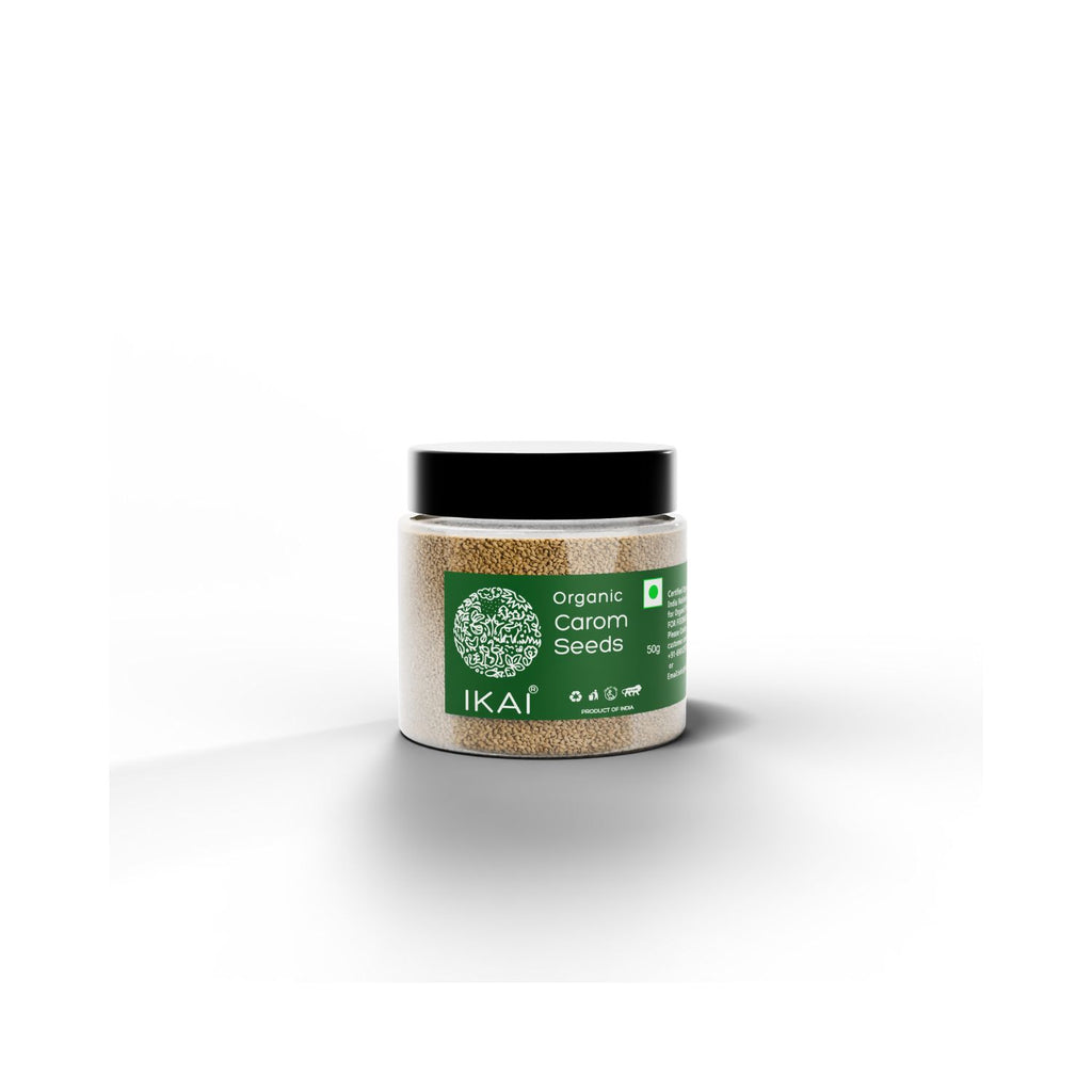 Jar of organic carom seeds with IKAI branding and black cap on a white background 