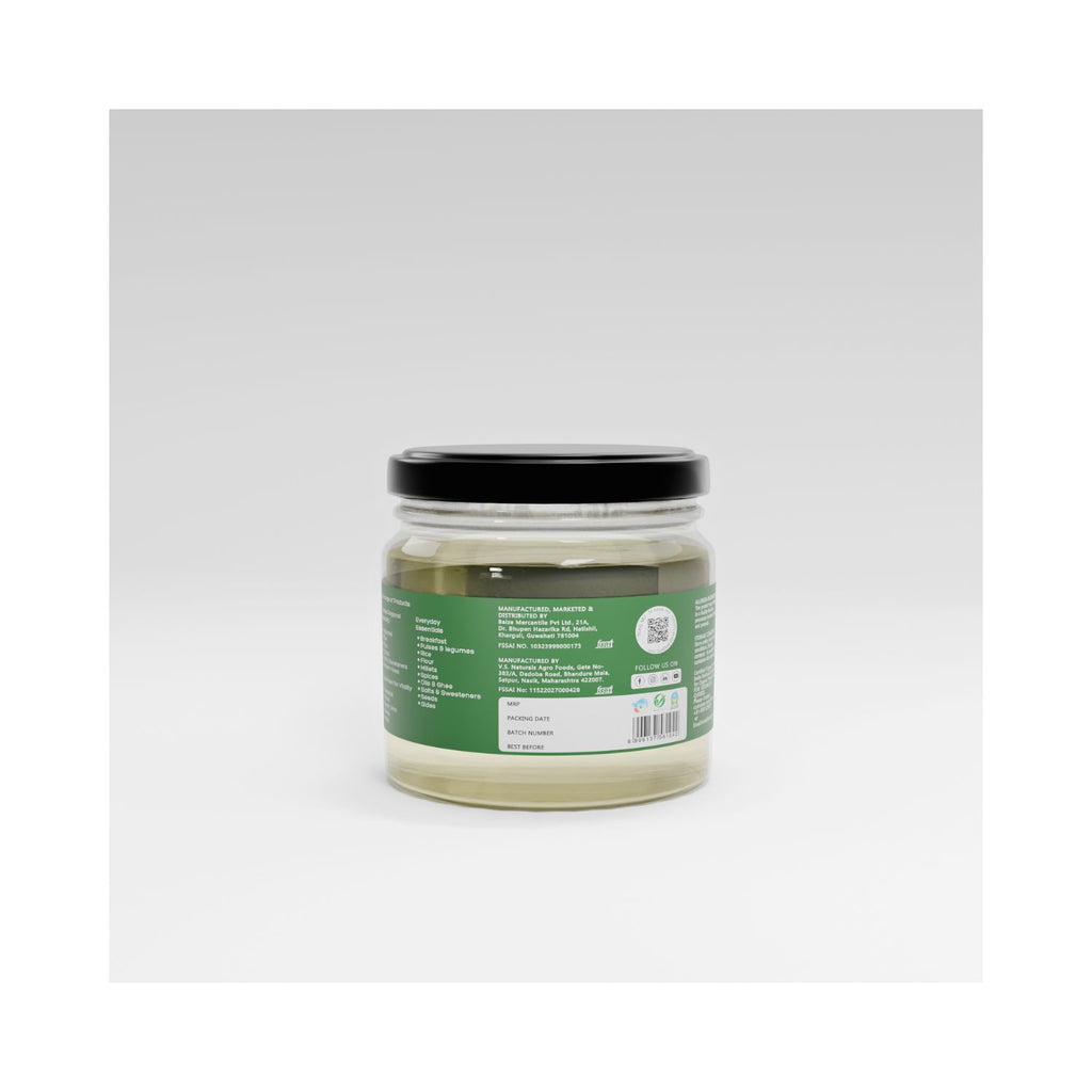 Jar of organic cold pressed coconut oil with a green label on a white background showing barcode and manufacturer info