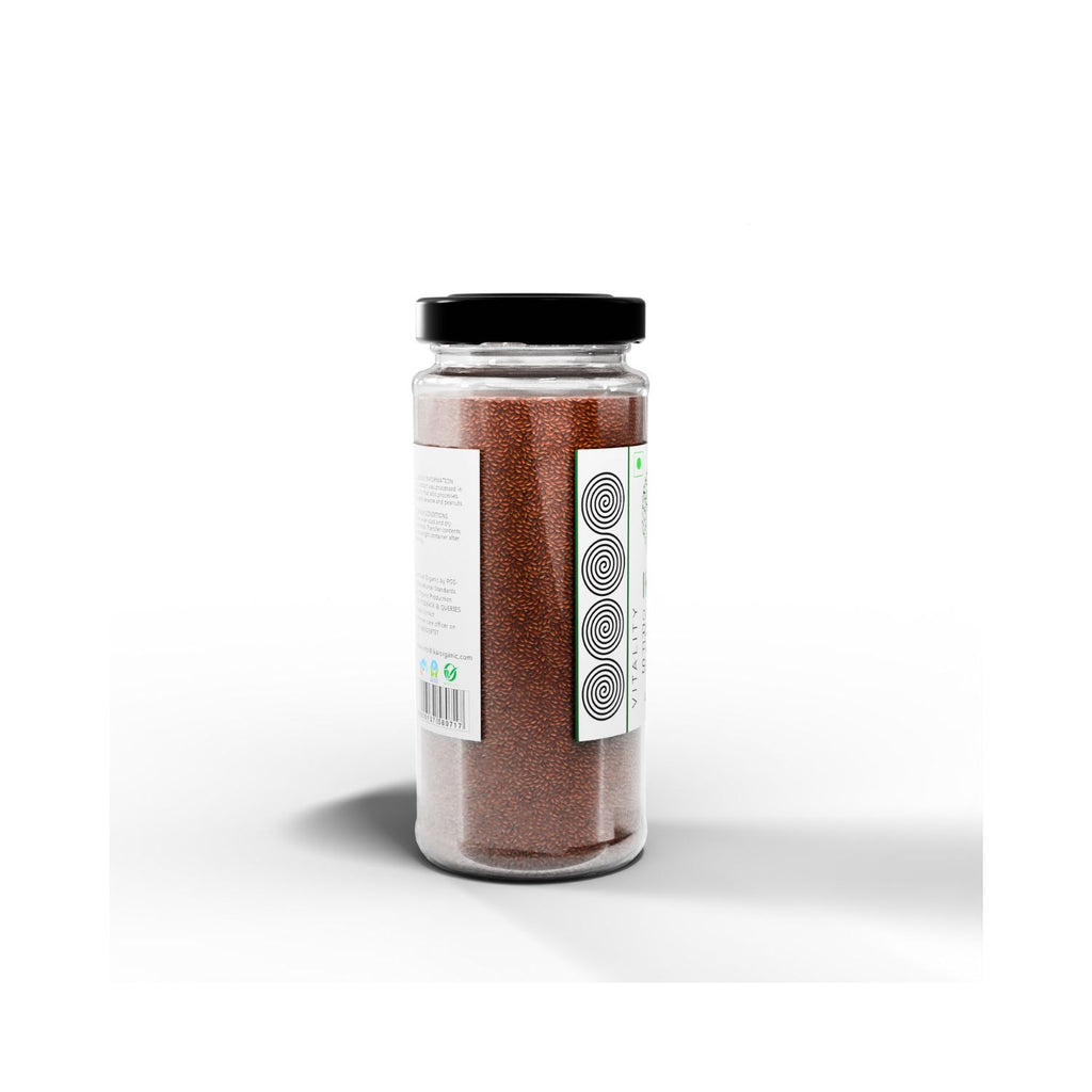 Jar of IKAI organic roasted flax seeds with a black lid on a white background