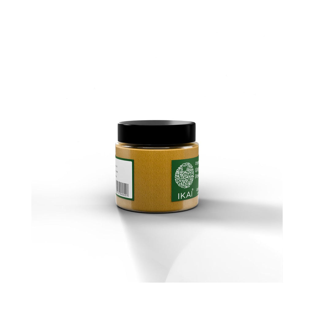 Jar of organic ginger powder with IKAI branding with a black lid and green label on a white background