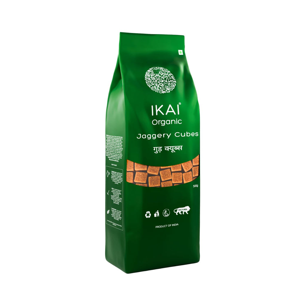 Green bag of IKAI Organic Jaggery Cubes on a white background