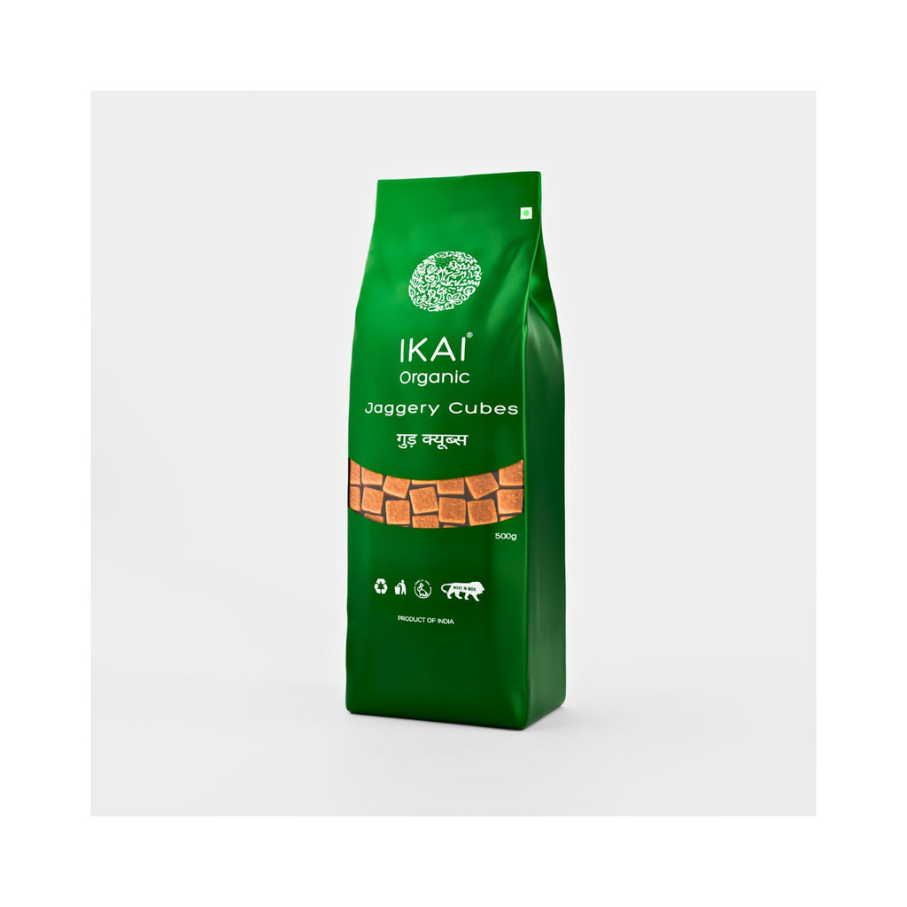 Green package of IKAI organic jaggery cubes on a white background different angle