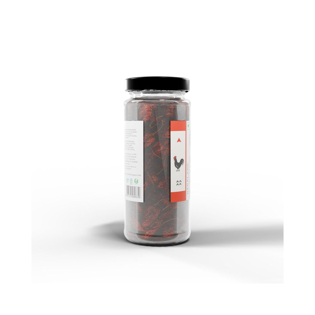 Jar of IKAI natural bhut jolokia with a label on a white background from a different angle