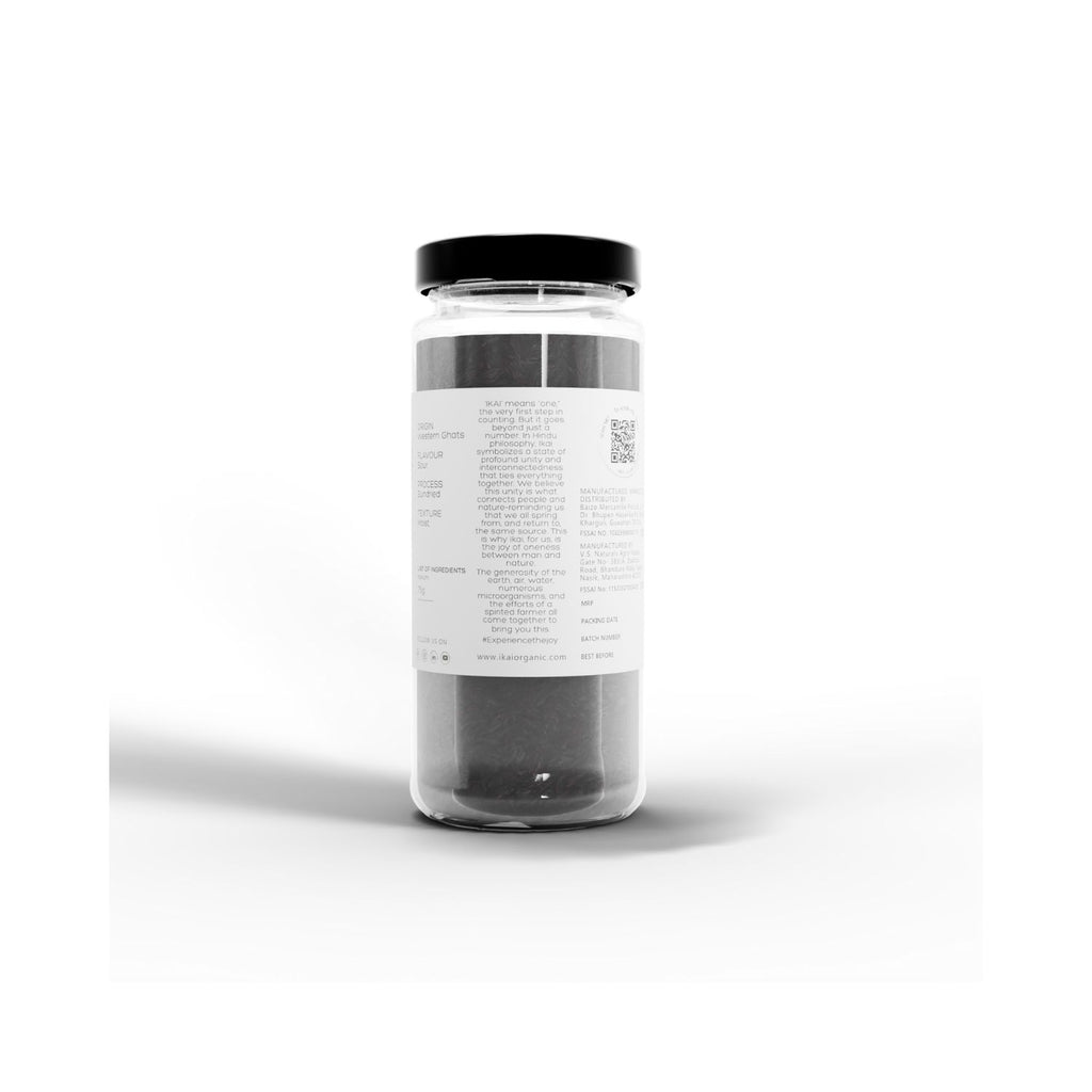 Clear jar with black lid of  IKAI natural kokum on a white background