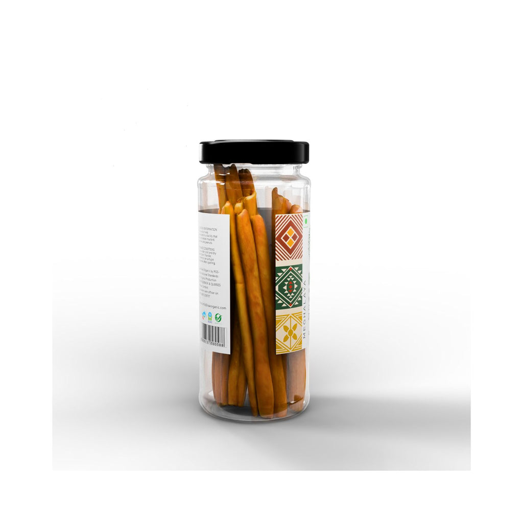 Jar of cinnamon sticks with a decorative label on a white background
