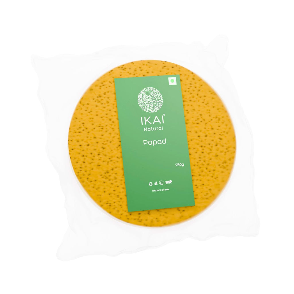 Yellow round papad with a green label on a white background