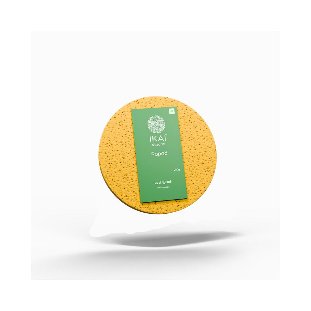 Pack of Yellow round papad with a green label on a white background