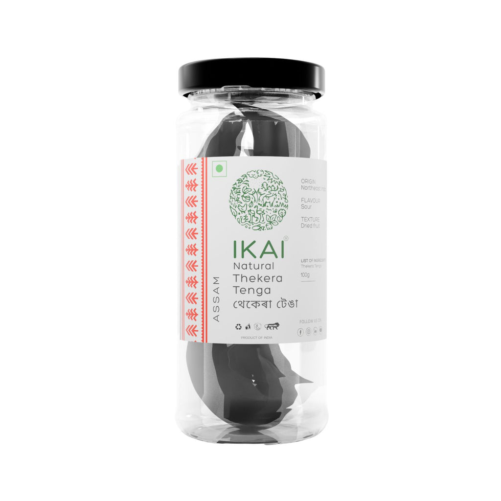 Jar of IKAI natural thekera tenga fruit spice in a clear container with a black lid on a white background